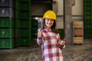 Beautiful Smiling Woman In A Plaid Shirt And With A Yellow Prote